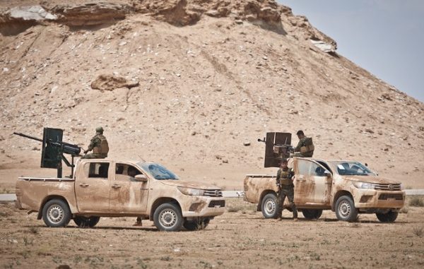 Syrian Democratic Forces (SDF) provide security for a Coalition mortar crew providing fires support to SDF against ISIS locations in Operation Round Up taking place in the Middle Euphrates River Valley (MERV) in Syria. (photo by SSG Timothy Koster, CJTF-OIR, May 13, 2018).